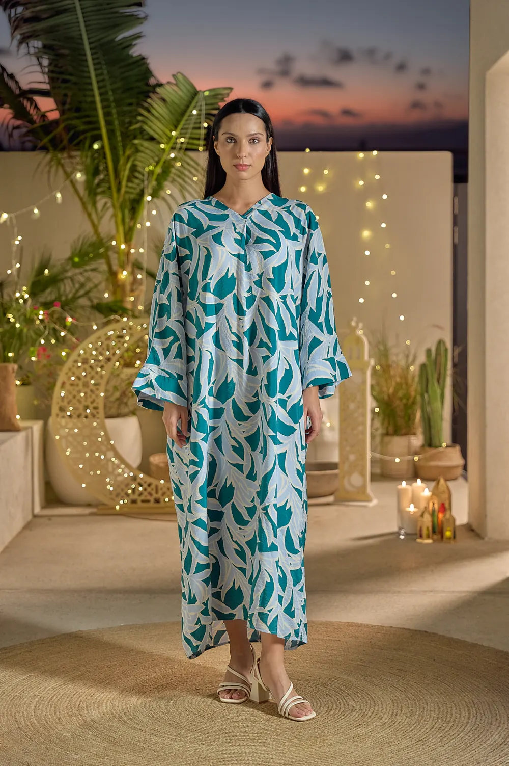 LC Waikiki Ramadan and Eid 2026 campaign photograph: a woman in a printed kaftan on a terrace at dusk.