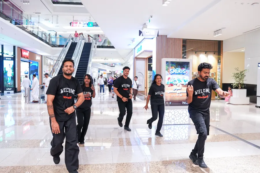 Performers in NEW YORKER Welcome T-shirts dancing through Reem Mall on opening day.