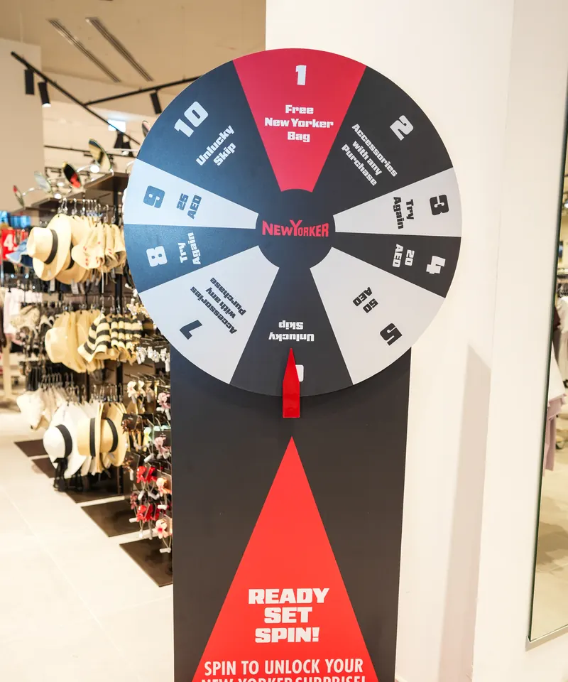The NEW YORKER spin-the-wheel stand offering guests an in-store surprise.