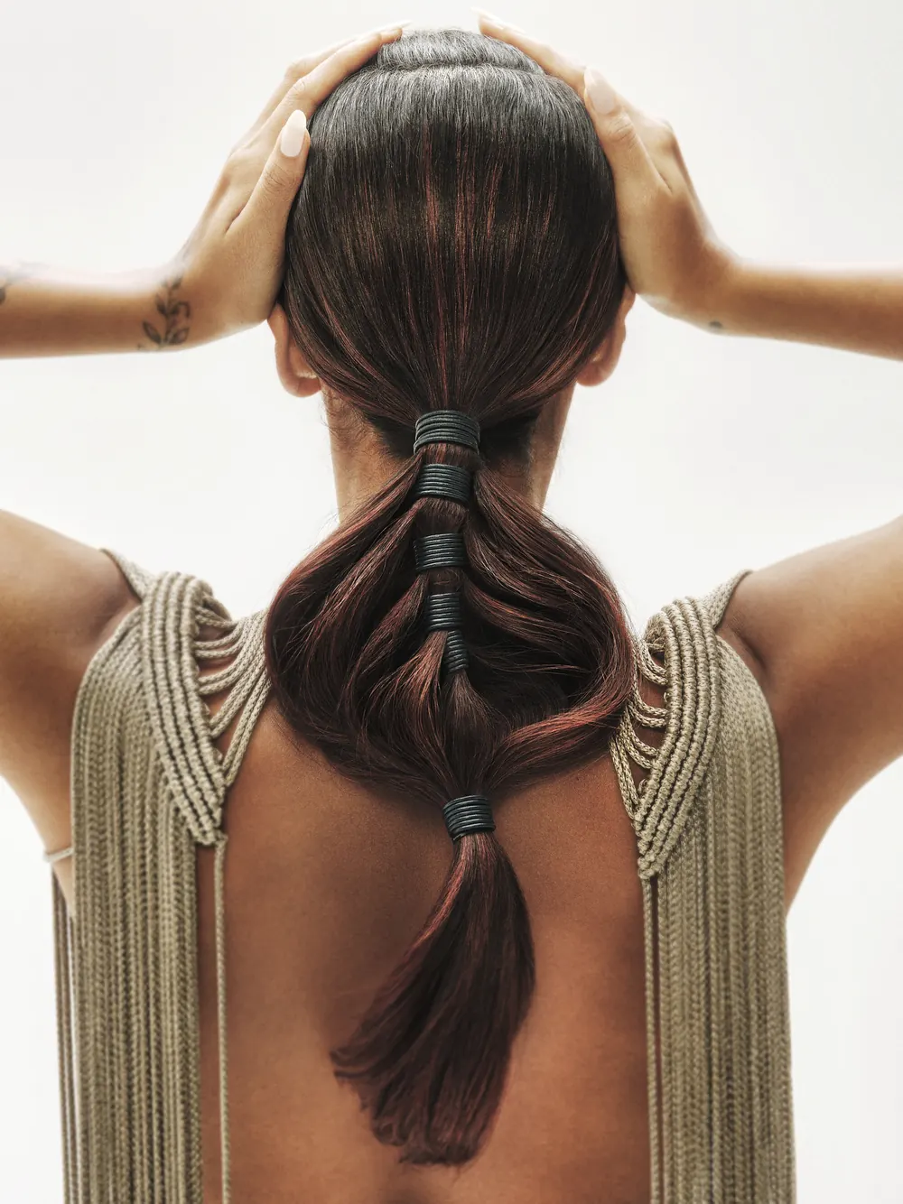 Pastels Collection Shoot 2024: a braided ponytail photographed from behind.