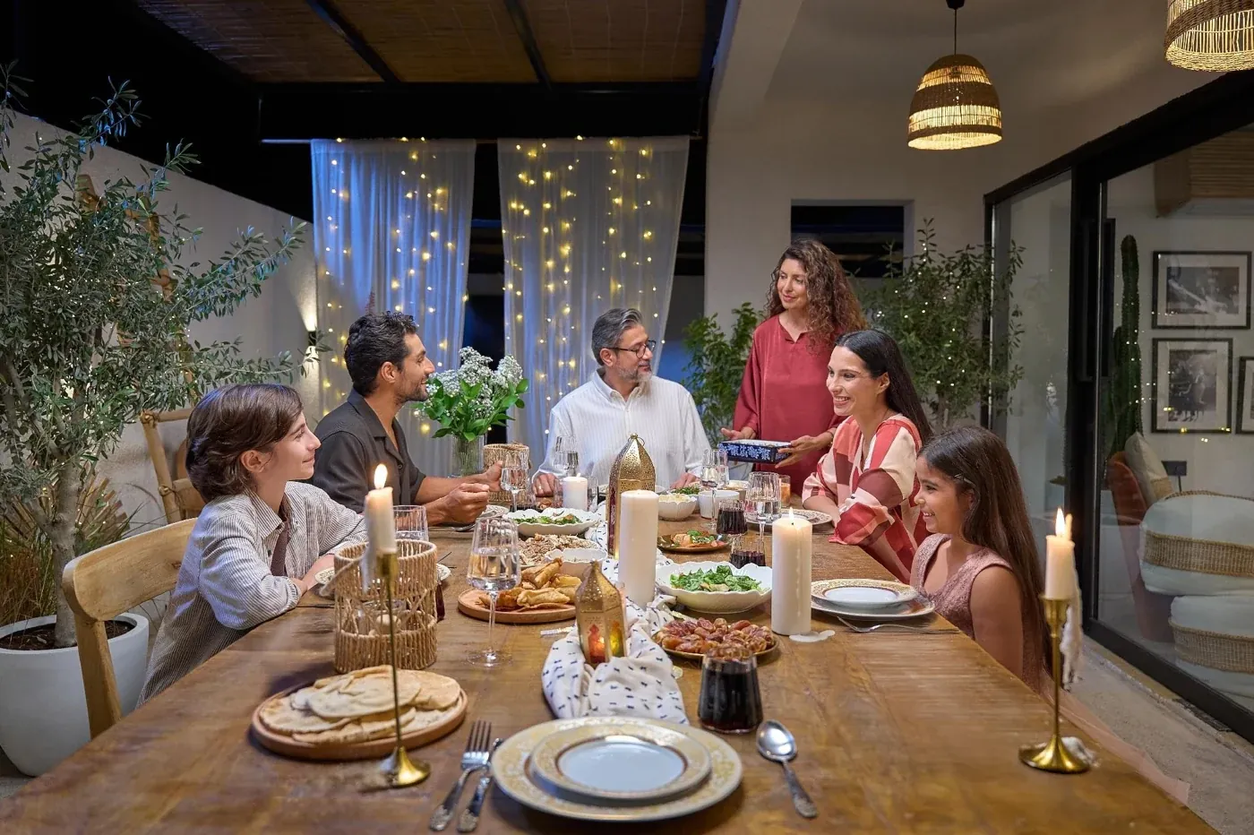 LC Waikiki Ramadan and Eid campaign photograph: a family gathered around a candlelit table in the evening.