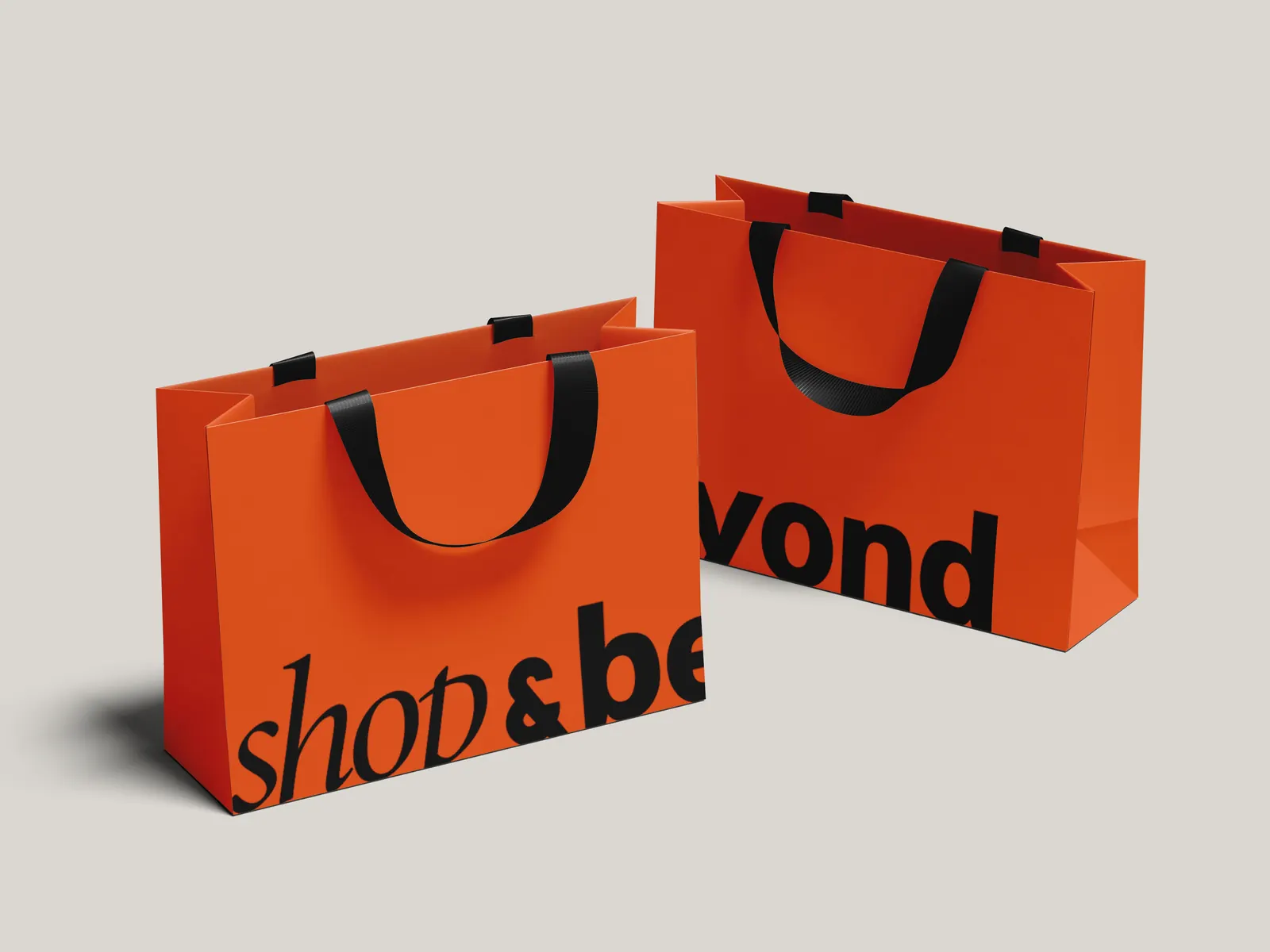 Shop & Beyond orange shopping bags with the black wordmark.