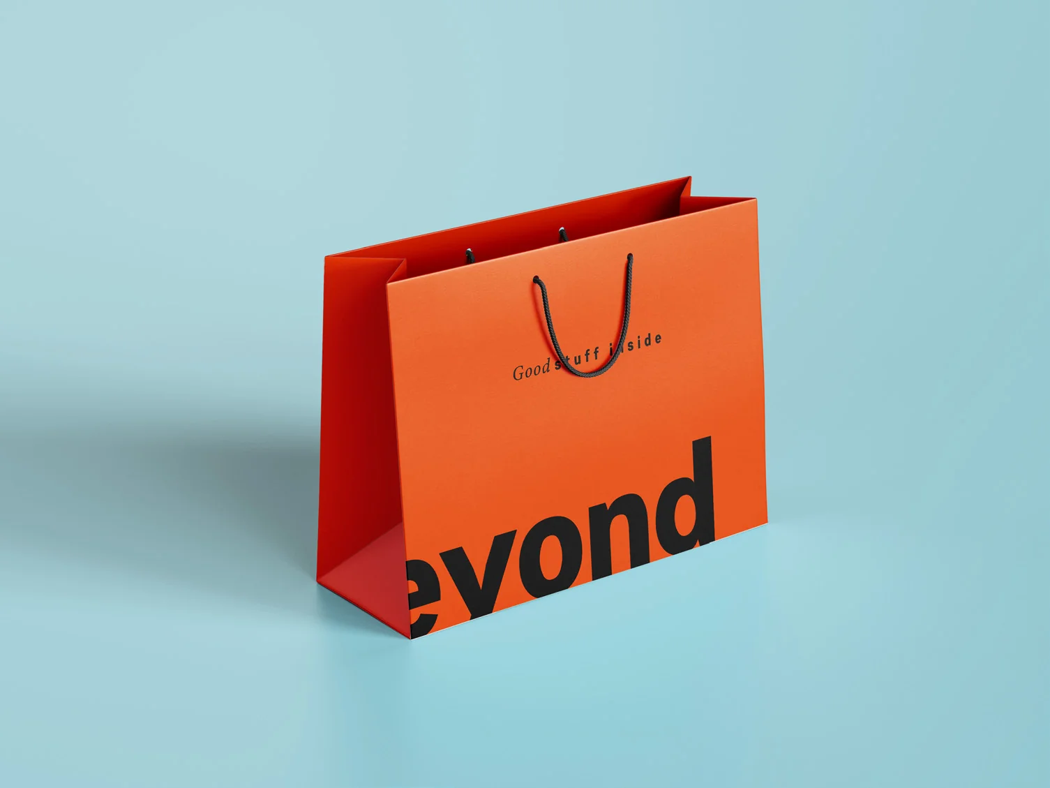 Design: the Shop & Beyond shopping bag in orange with the black wordmark, from the brand book.