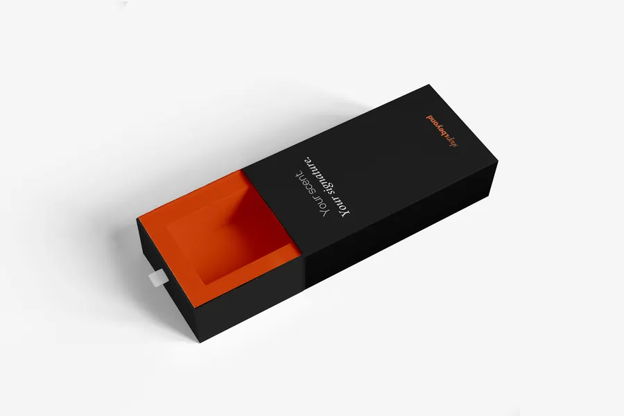 The Shop & Beyond perfume box, black outside and orange inside.