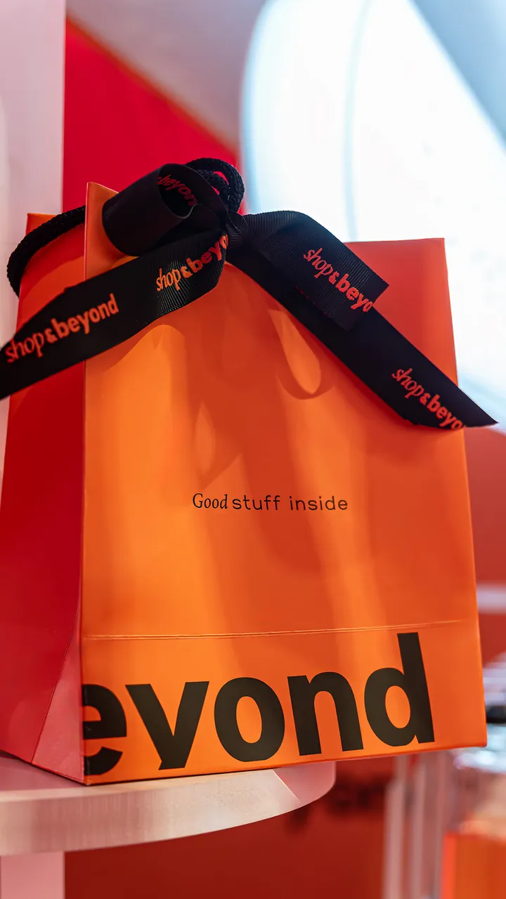Instagram story: a Shop & Beyond bag tied with the branded ribbon, with the line “Good stuff inside”.