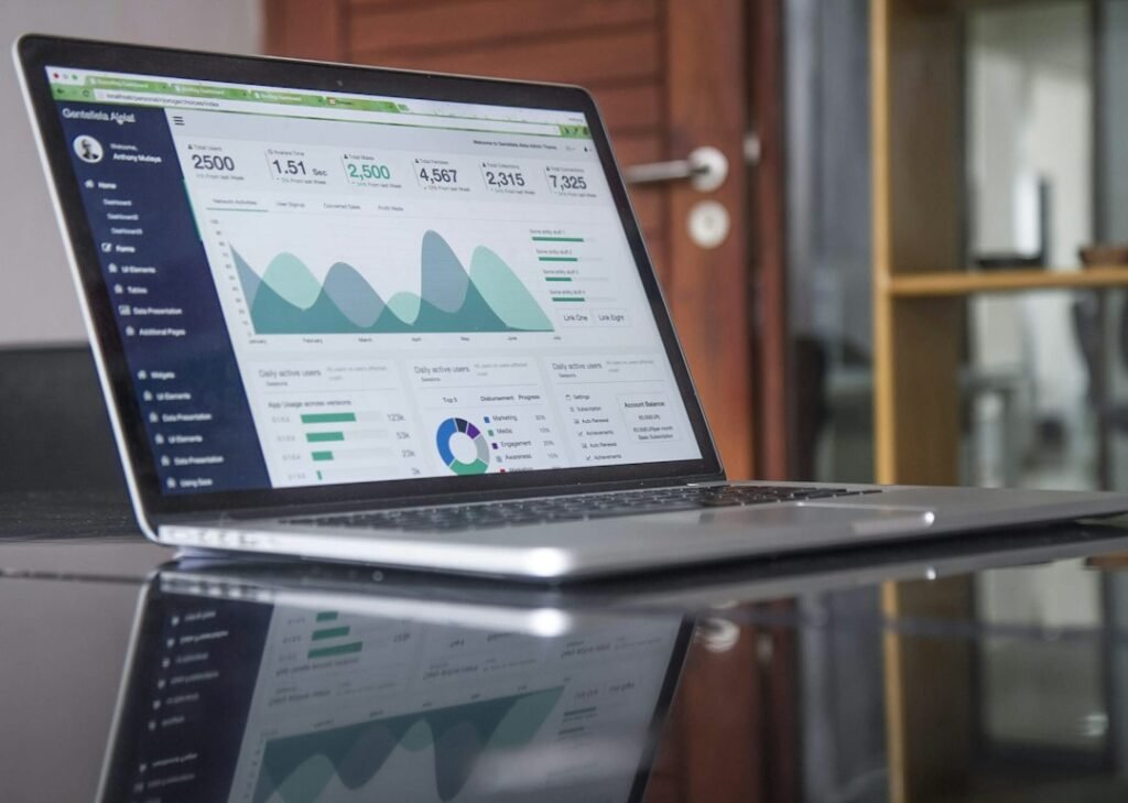 Laptop displaying business analytics and growth metrics